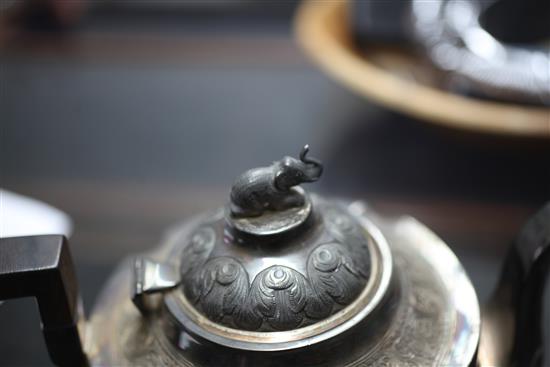 A heavy late 19th century Indian three piece silver tea set,